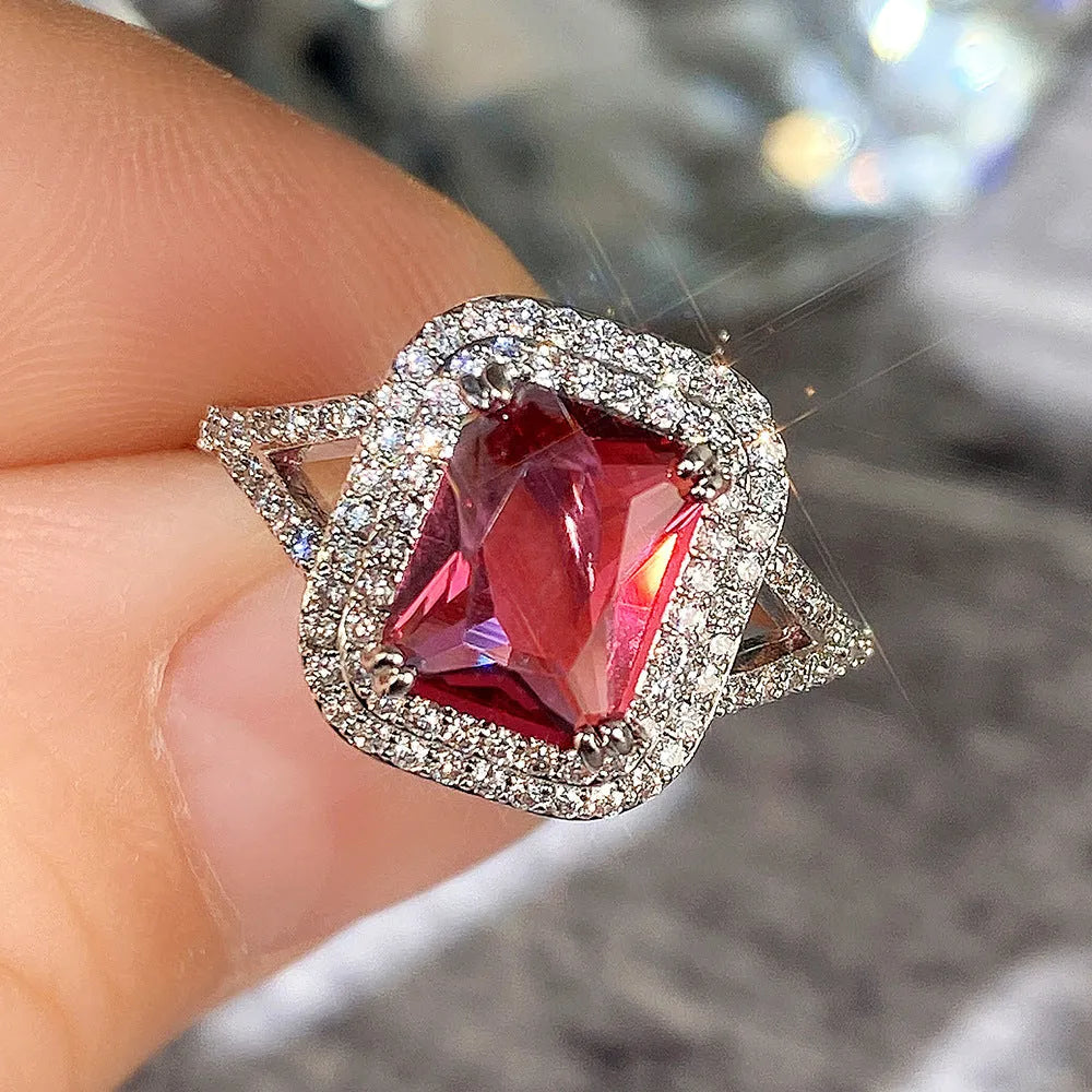 Copper geometric square ring with rhinestones in F827 red, shown on a finger.