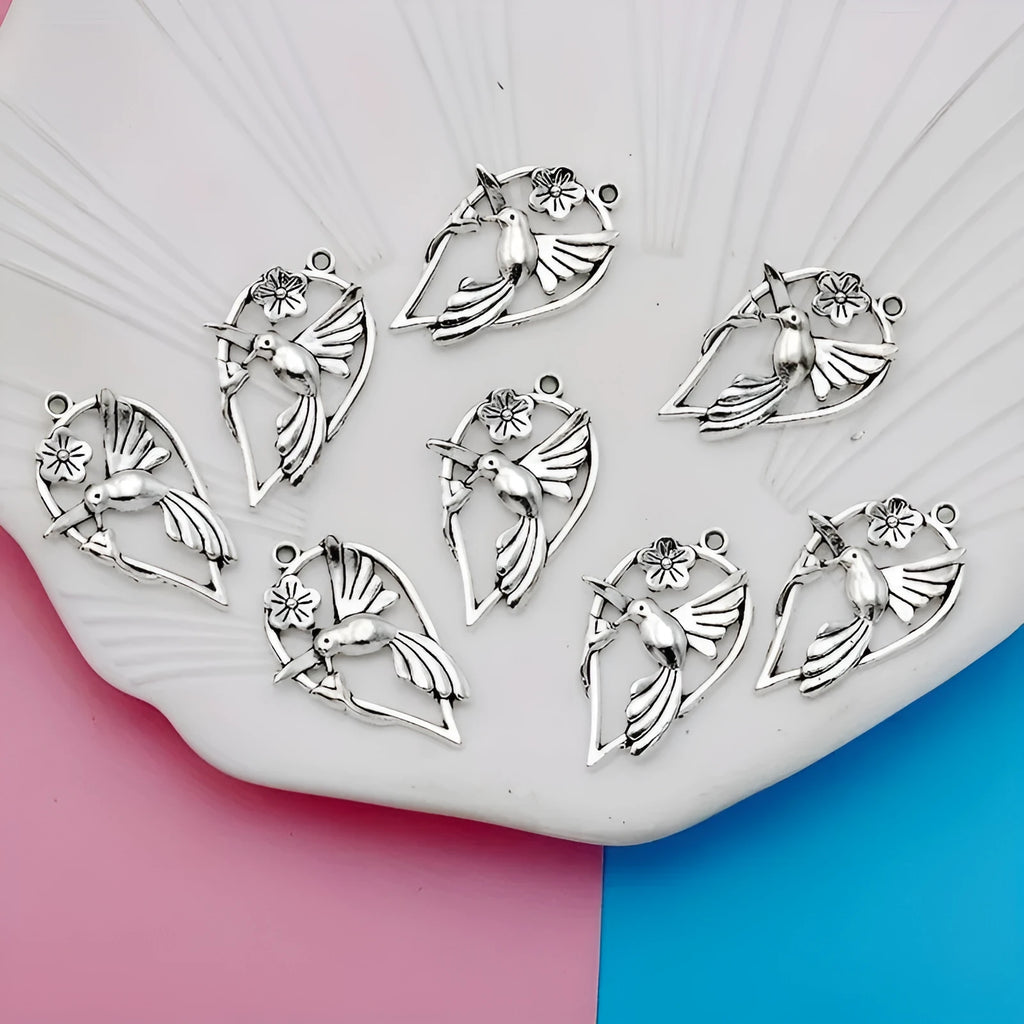 Close-up of a silver-toned alloy cuckoo bird pendant with a magpie pattern, for DIY jewellery making.