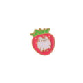Close-up of a cute cat strawberry dripping oil cake design alloy metal brooch on a fabric background.