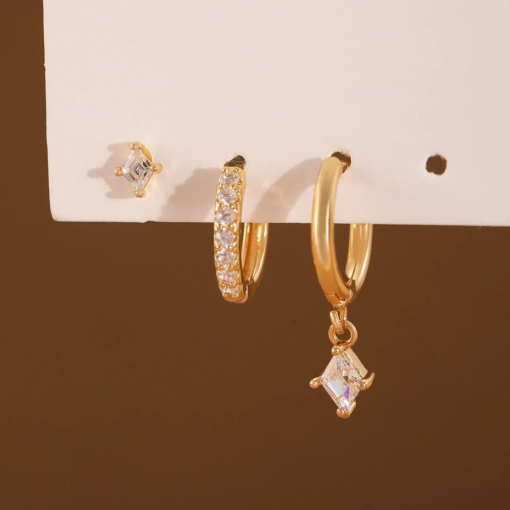 Women's three-piece geometric zircon earring set in gold showing pendant, stud, and clip-on styles