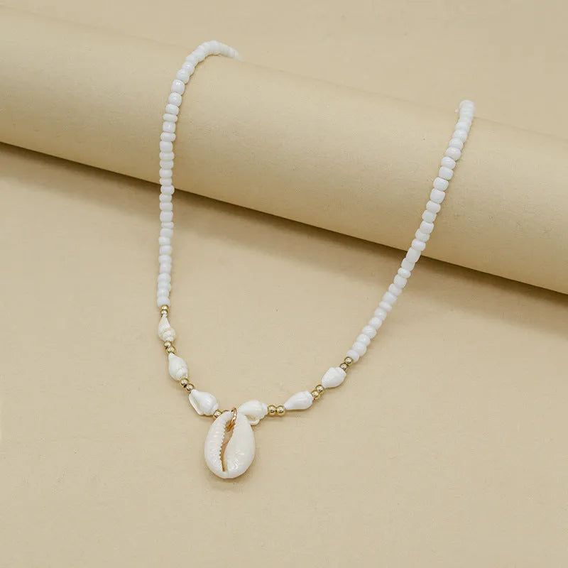 White Mother of Pearl conch shell pendant necklace on an electroplated chain.