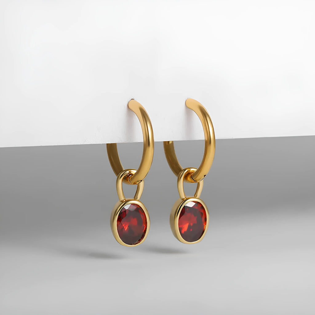 Women's oval-shaped retro zircon earrings in copper, shown in emerald green colour.