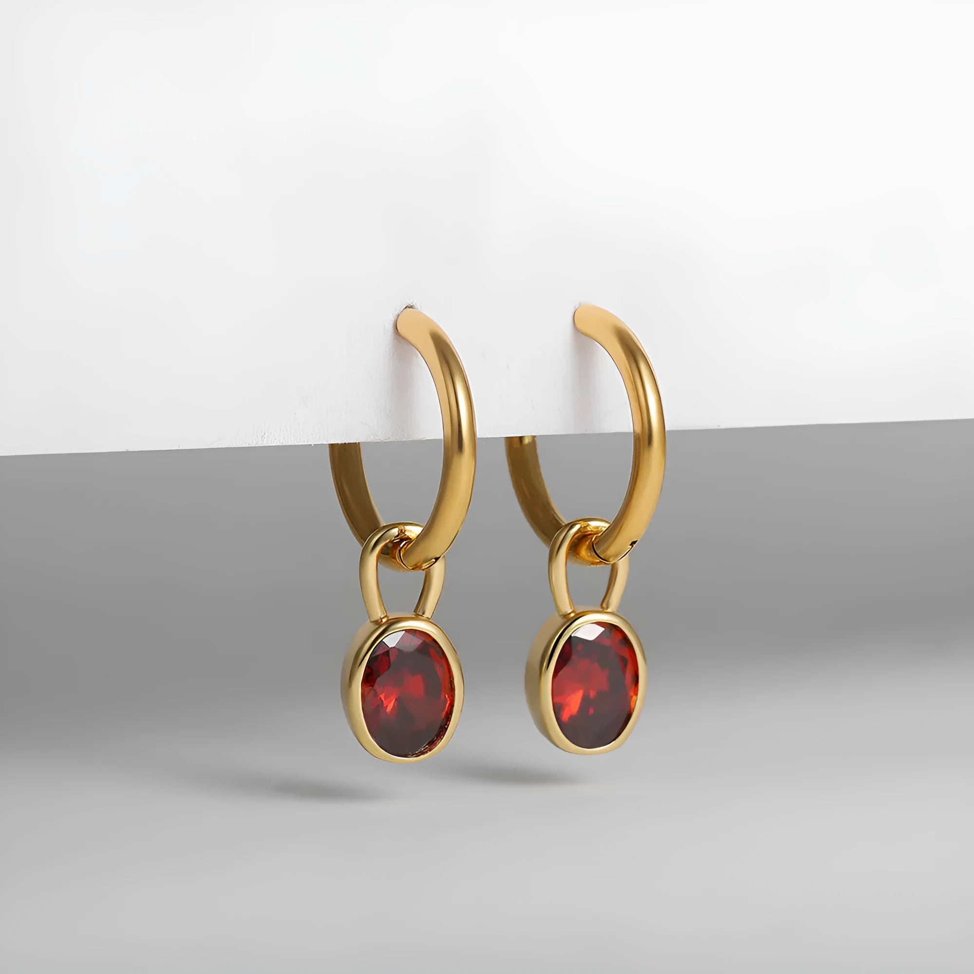Women's oval-shaped retro zircon earrings in copper, shown in emerald green colour.