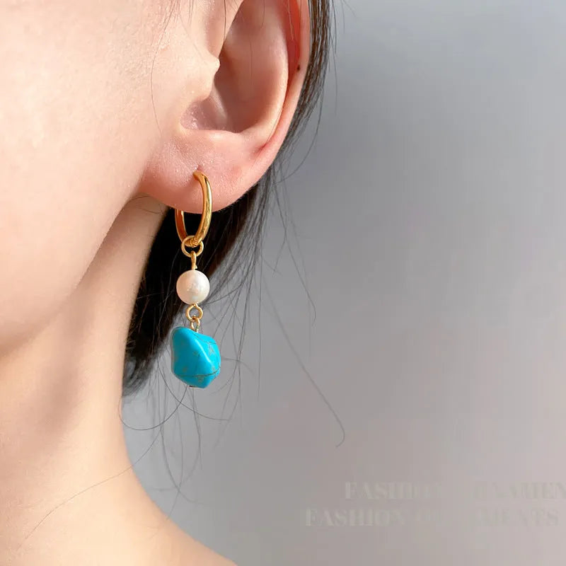 Irregular turquoise and cultured pearl earrings with geometric copper settings in both dangle and stud styles