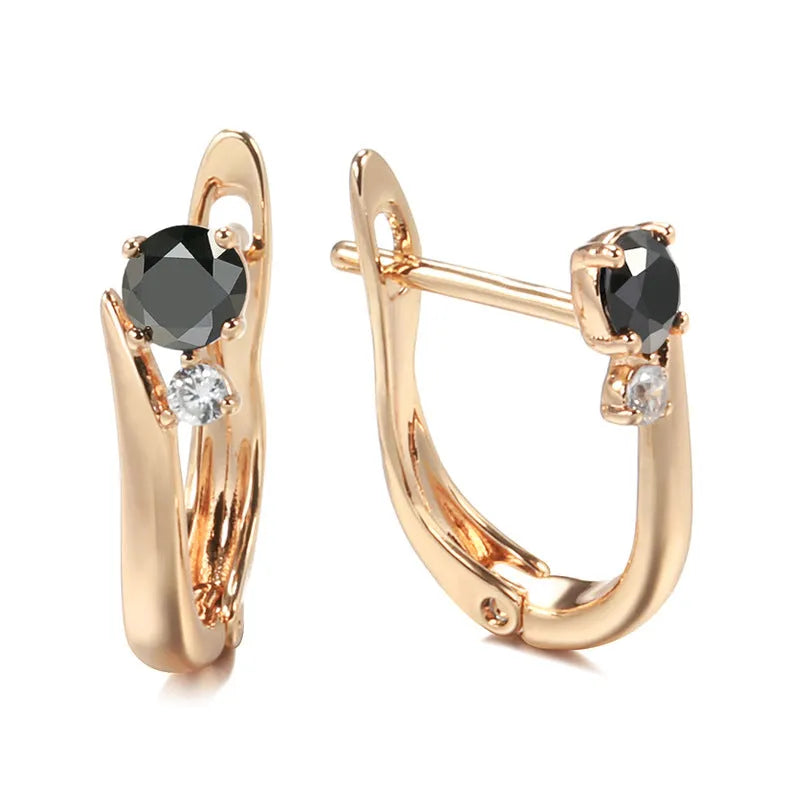 Gold drop-shaped earrings with geometric patterns and artificial gemstone inlay