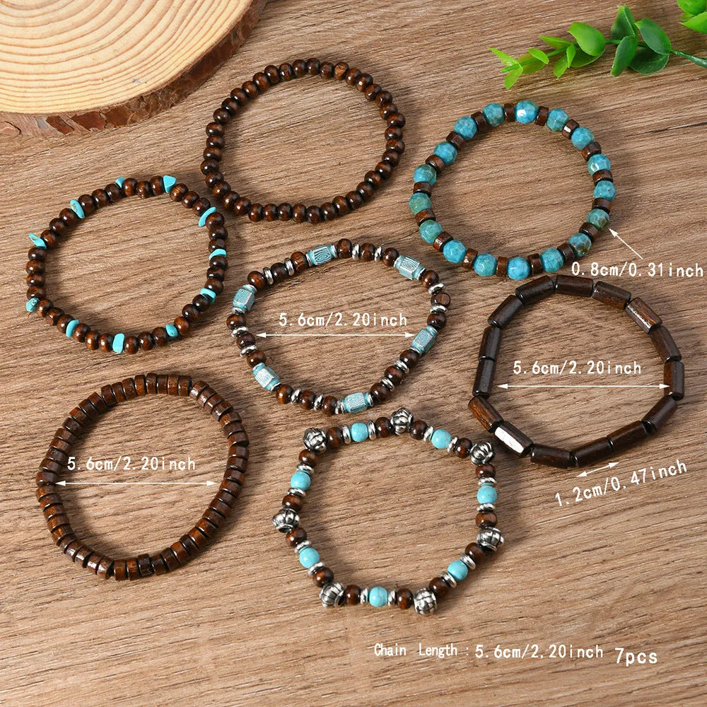 Seven multicoloured retro bracelets with wooden beads and alloy metal components arranged together