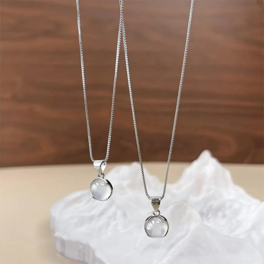 Women's oval artificial crystal pendant necklace with eight-point star detail on adjustable box chain