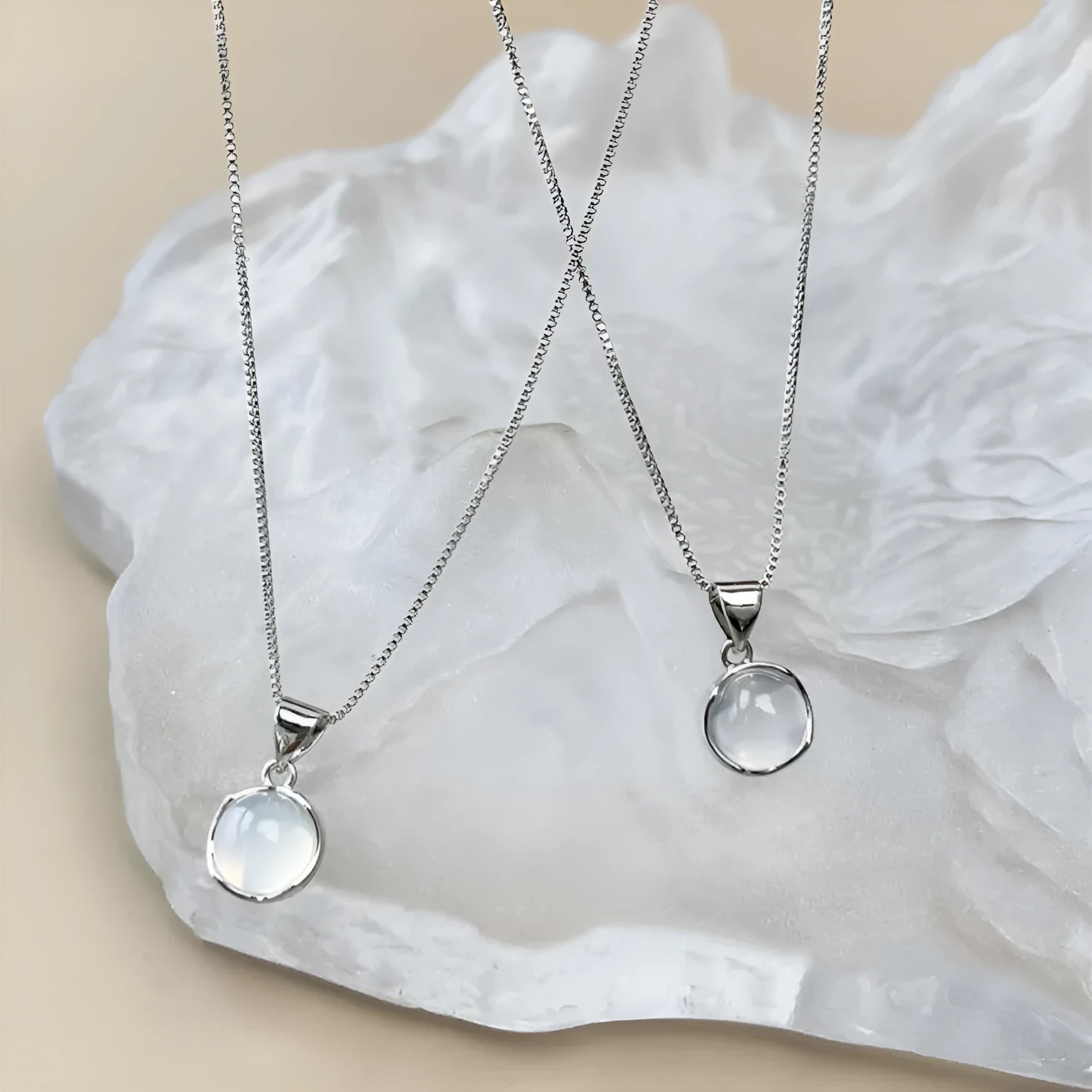 Women's oval artificial crystal pendant necklace with eight-point star detail on adjustable box chain
