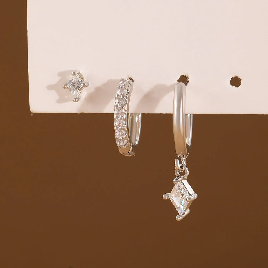 Women's three-piece geometric zircon earring set in gold showing pendant, stud, and clip-on styles