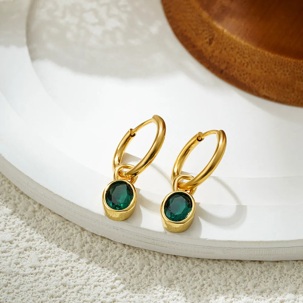 Women's oval-shaped retro zircon earrings in copper, shown in emerald green colour.