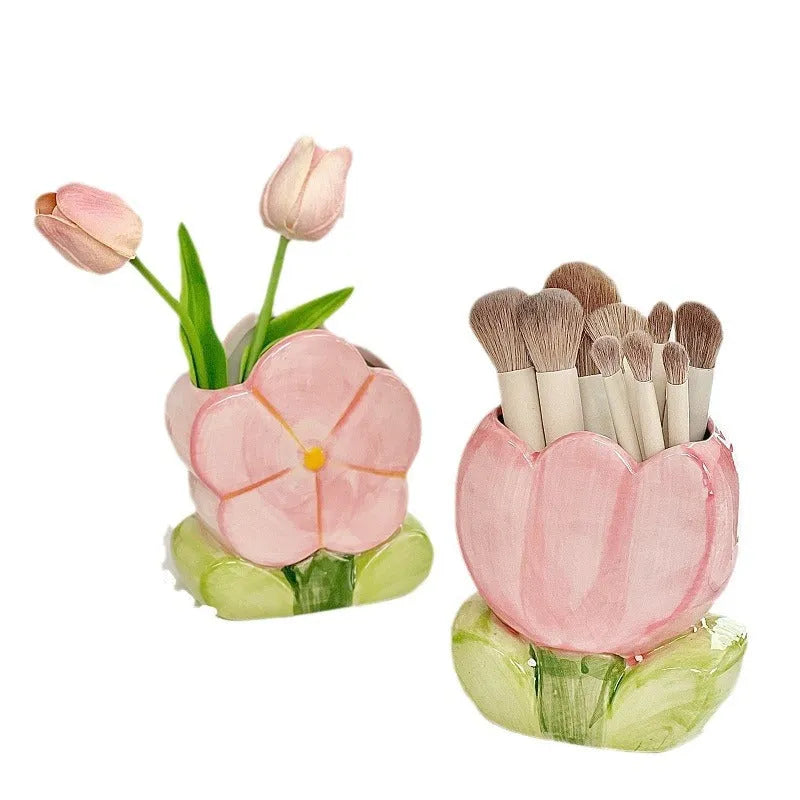 Ceramic flower pen holder in a floral pattern, showing its size next to pens for scale.