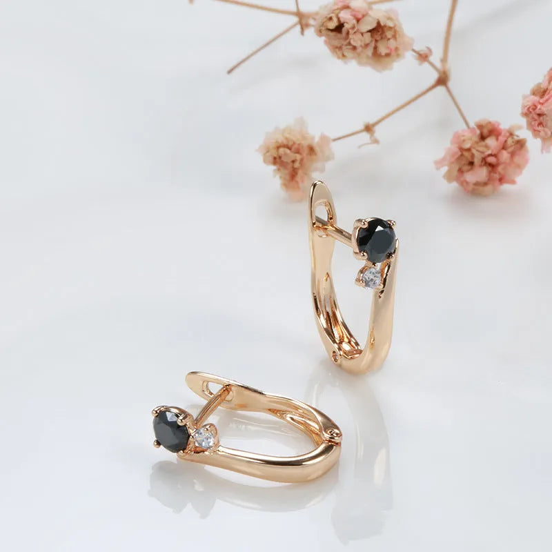 Gold drop-shaped earrings with geometric patterns and artificial gemstone inlay