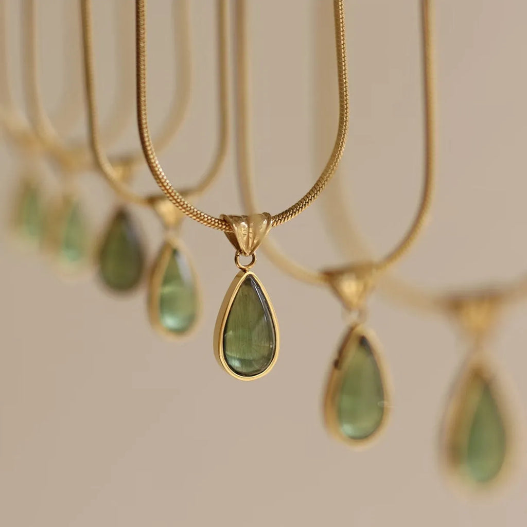 Retro titanium steel necklace with blue gemstone water drop pendant on a snake chain.