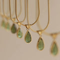 Retro titanium steel necklace with blue gemstone water drop pendant on a snake chain.