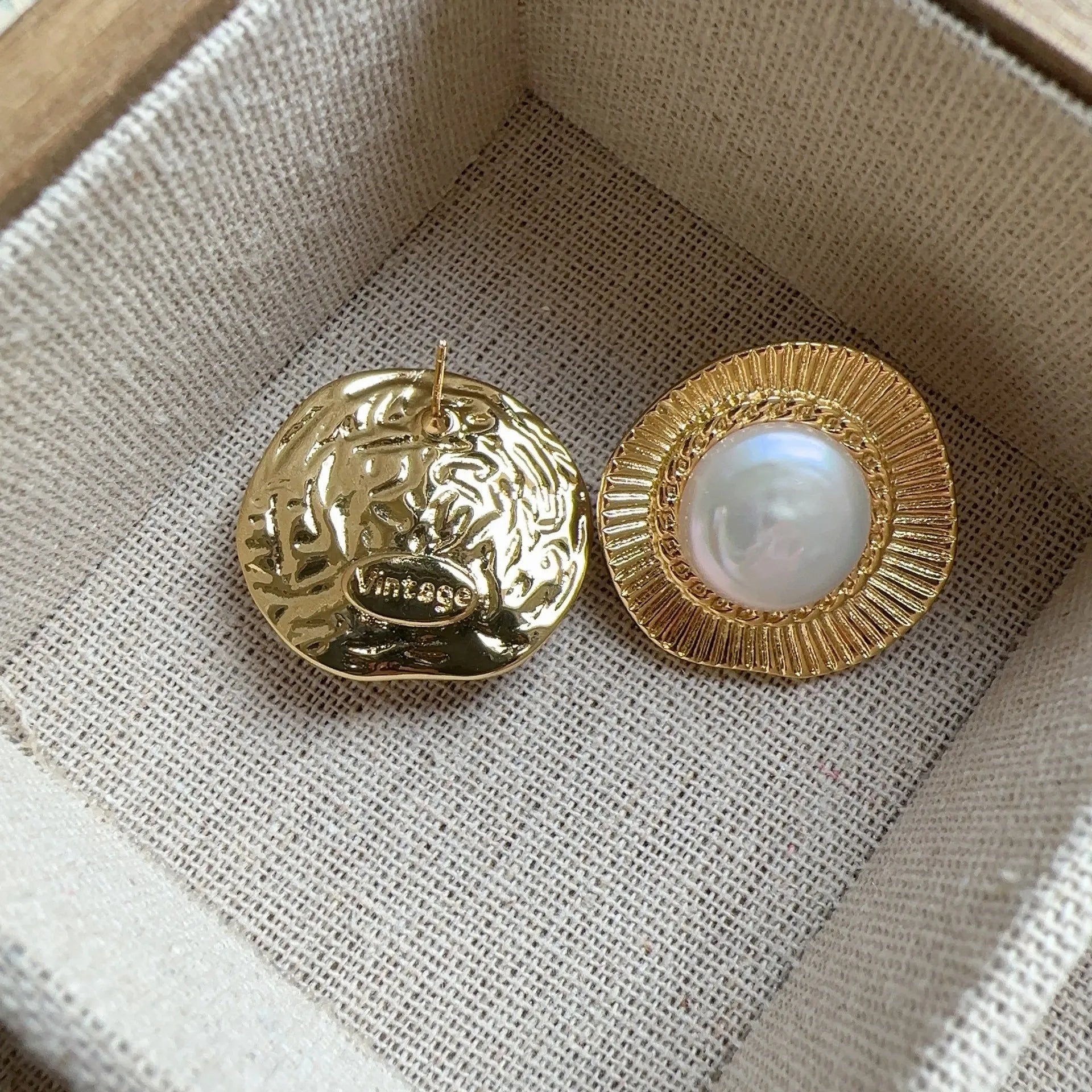 A pair of round, gold-tone retro style metal earrings for women