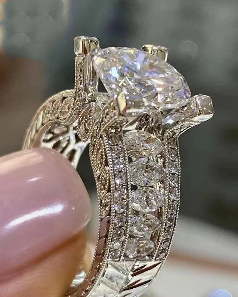 Geometric women's silver fashion ring with round details in gold or white electroplated finish on a finger.