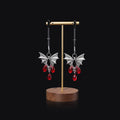 Silver bat nipple clamp with ruby detail and adjustable mechanism