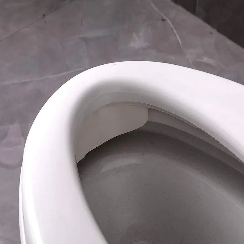 White PVC toilet urine blocking board for children's training placed on toilet rim
