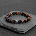 Handmade elastic bracelet with natural tiger-eye stone beads in a geometric minimalist design.