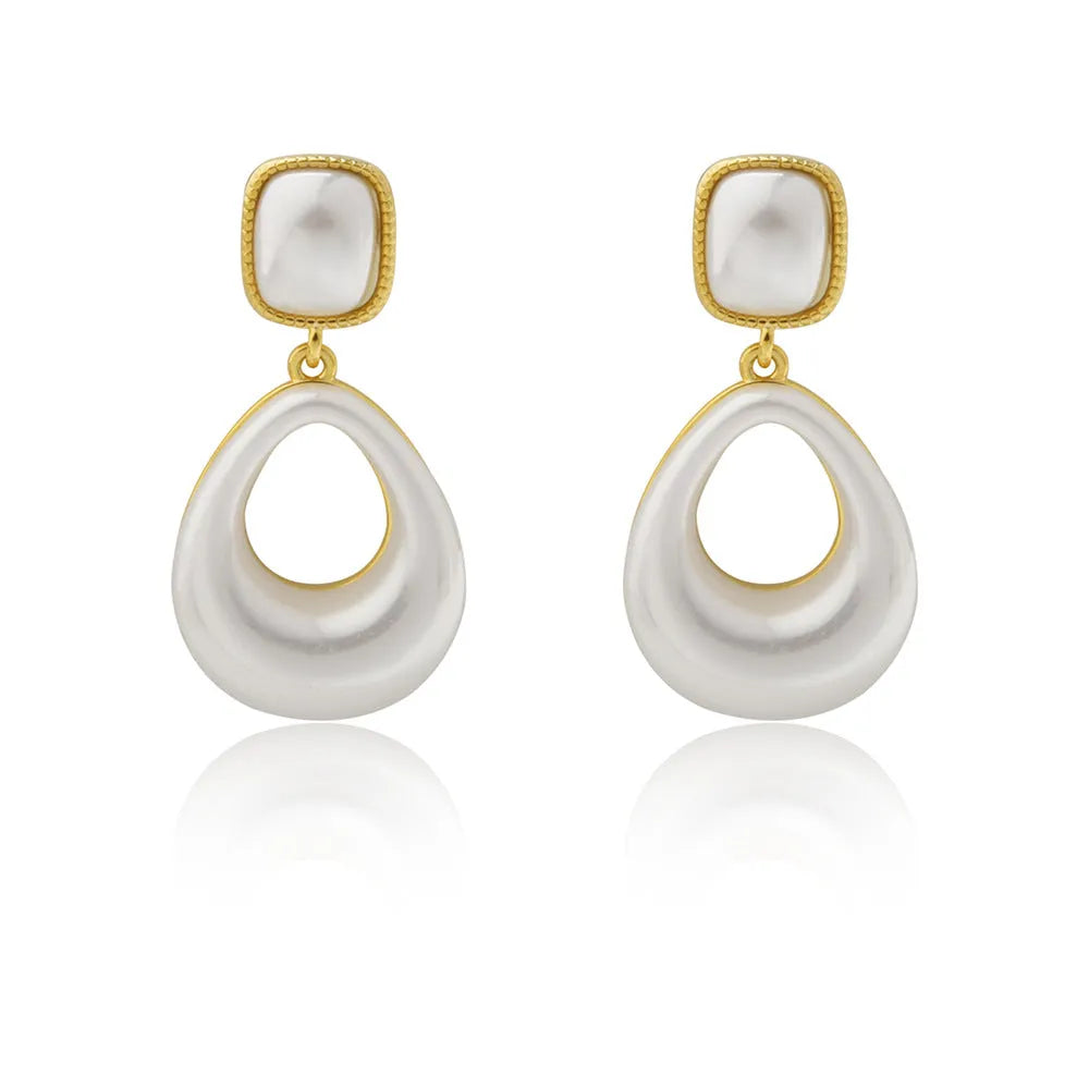 Gold coloured drop shaped earrings with a central imitation pearl, shown on a white background.