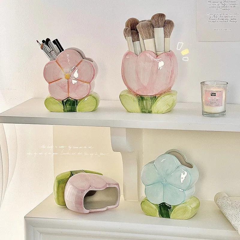 Ceramic flower pen holder in a floral pattern, showing its size next to pens for scale.