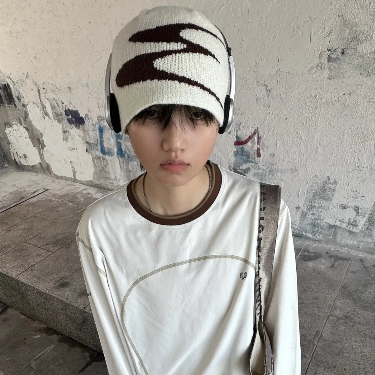 Acrylic thermal knit beanie hat in black on a white background, showing ribbed texture.