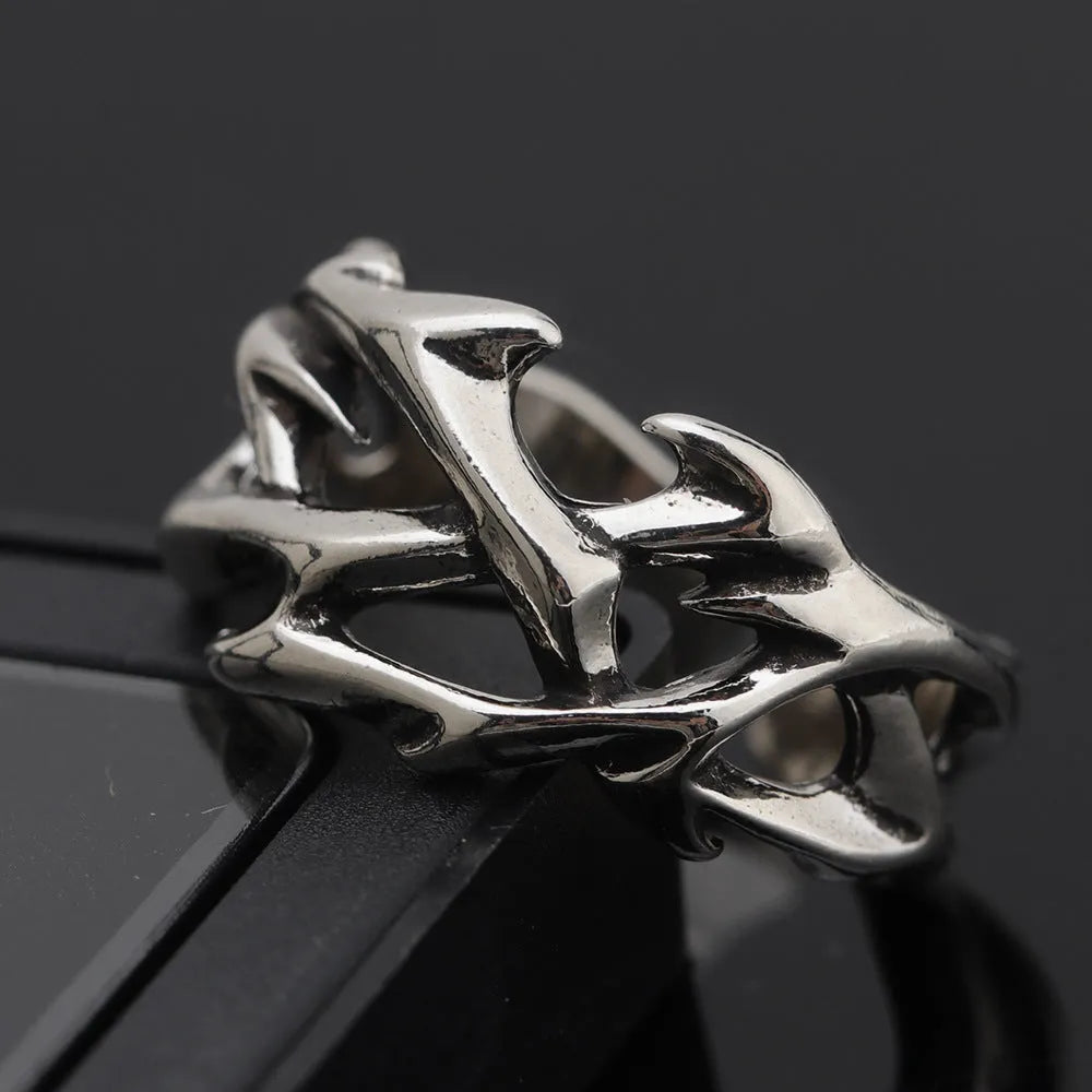 Copper men's ring with geometric thorn and flower design on an adjustable band.