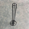 Black wrought iron coffee capsule storage rack holding pods on shelving, modern simple design.