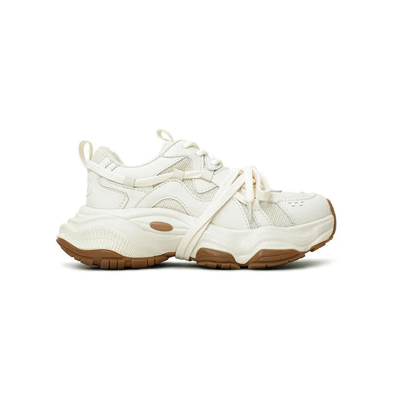 Women's beige platform sneaker with round toe and lace-up front on a white background.