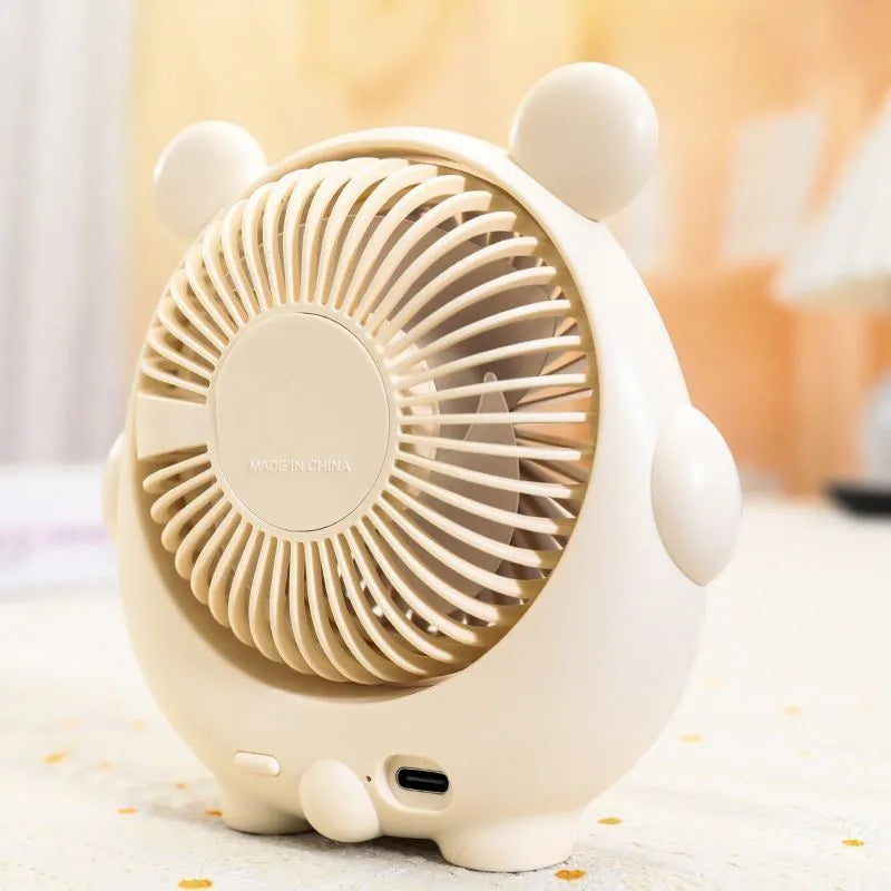 Cute dog-shaped USB desktop electric fan in a choice of colours including brown and pink, showing its plastic construction.