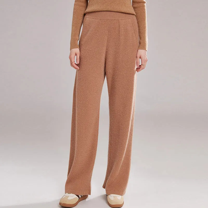 Women's thick cashmere leggings in green velvet colour, showing high elasticity and stitching detail.