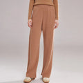 Women's thick cashmere leggings in green velvet colour, showing high elasticity and stitching detail.
