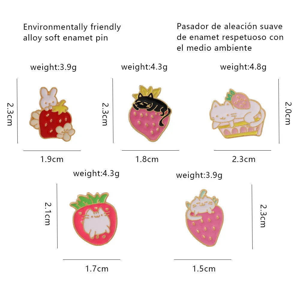 Close-up of a cute cat strawberry dripping oil cake design alloy metal brooch on a fabric background.