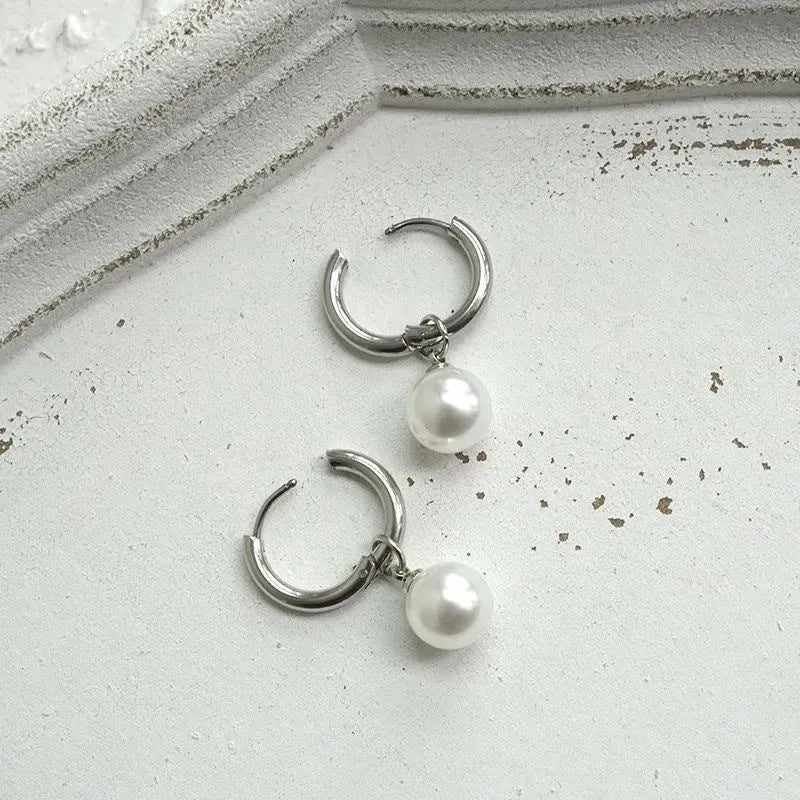 Geometric pearl drop earrings with titanium steel alloy construction and round element accents
