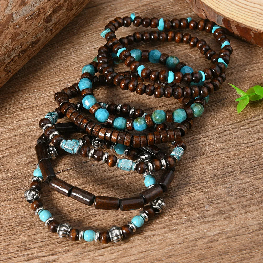 Seven multicoloured retro bracelets with wooden beads and alloy metal components arranged together