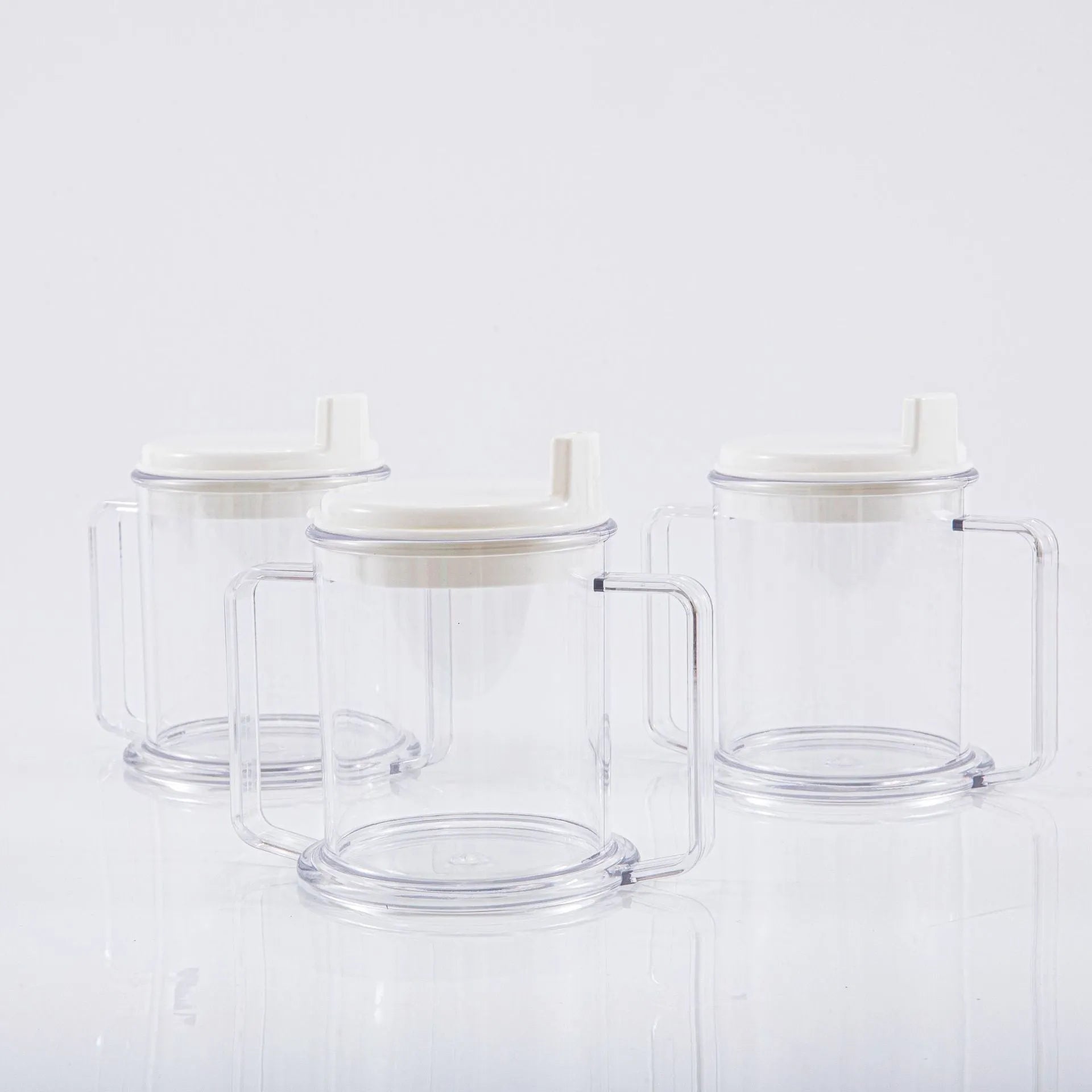 Transparent spill-proof drinking cup with straw lid showing modern minimalist design