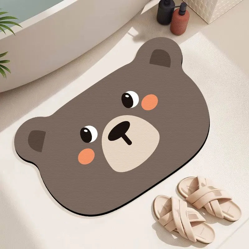 Cartoon animal diatom oil absorbent non-slip bathroom mat in alien shape on a bathroom floor.