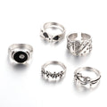 Black alloy ring with a detailed retro spade card poker design on a finger.