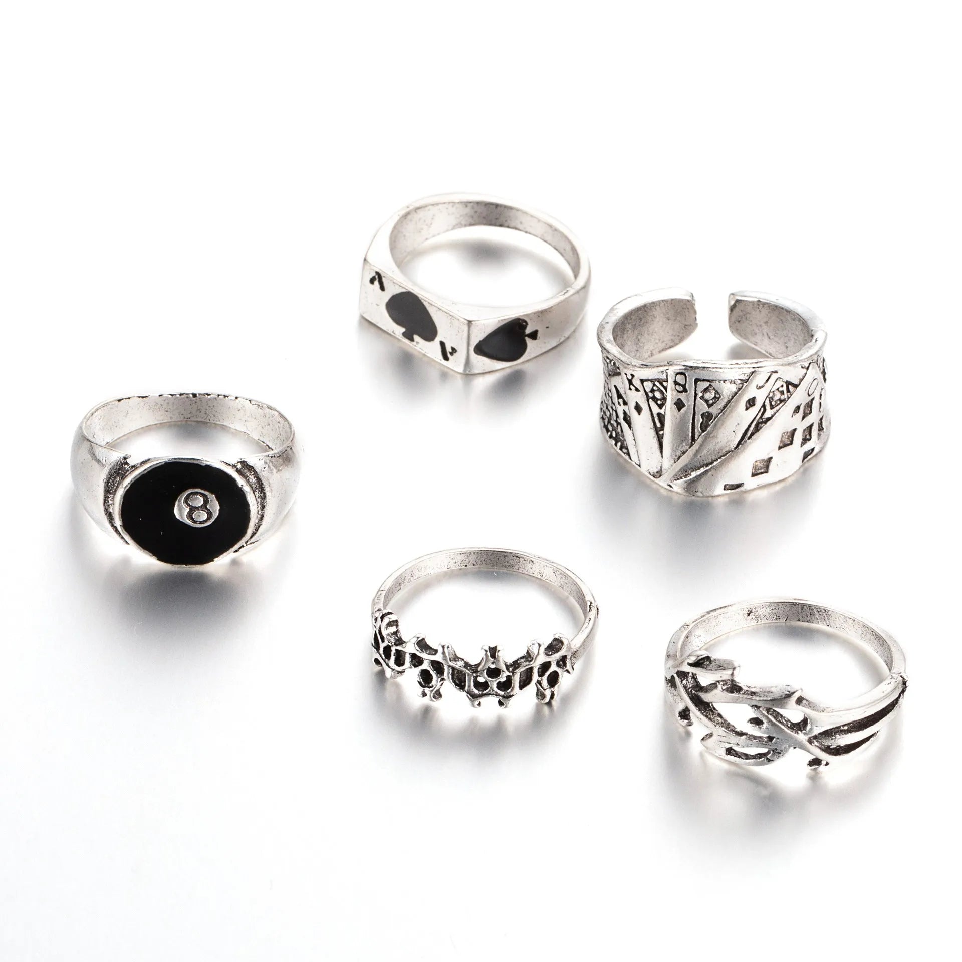 Black alloy ring with a detailed retro spade card poker design on a finger.