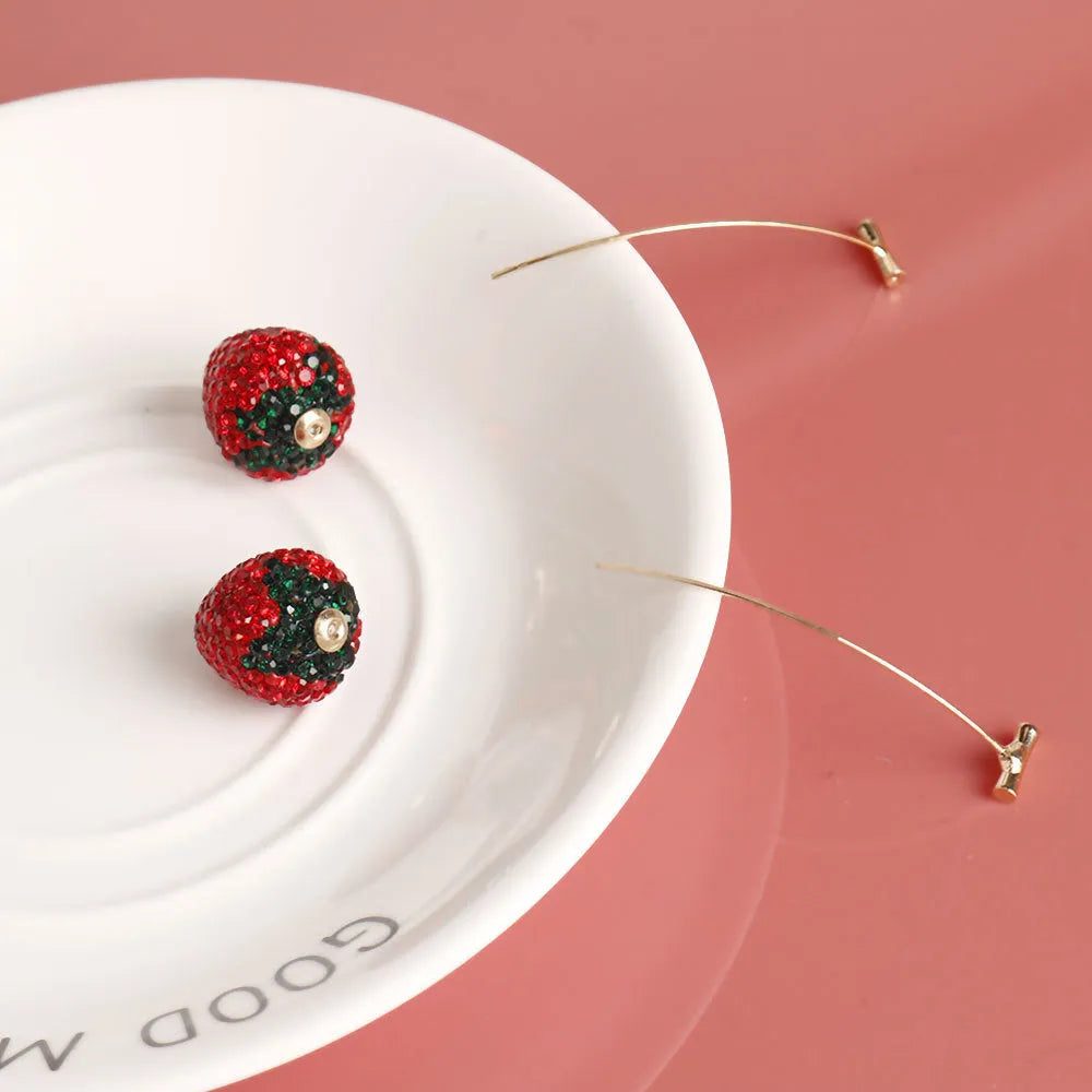 A pair of geometric strawberry-shaped stud earrings with spot drill texture, shown in red zinc alloy.