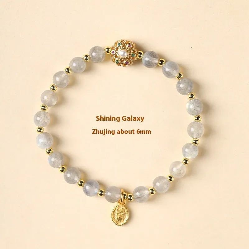 Gray moonstone and pink sunstone crystal bracelet with hand-woven cord and peach blossom quartz charms.