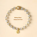 Gray moonstone and pink sunstone crystal bracelet with hand-woven cord and peach blossom quartz charms.