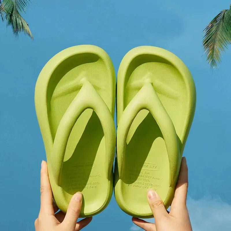 A pair of solid colour thick-soled EVA flip-flops with a bow detail on the strap.