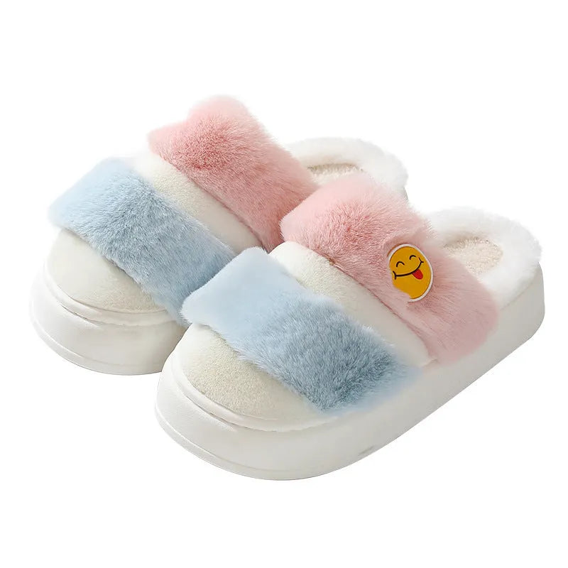 Thermal plush slippers with cashmere lining in pink and green colour block, showing non-slip sole.
