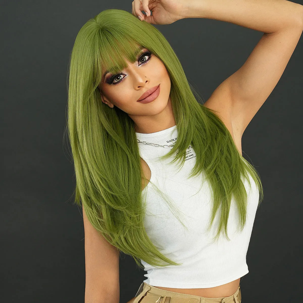 A woman wearing a long, straight vanilla green wig with a full fringe, measuring 63cm in length.