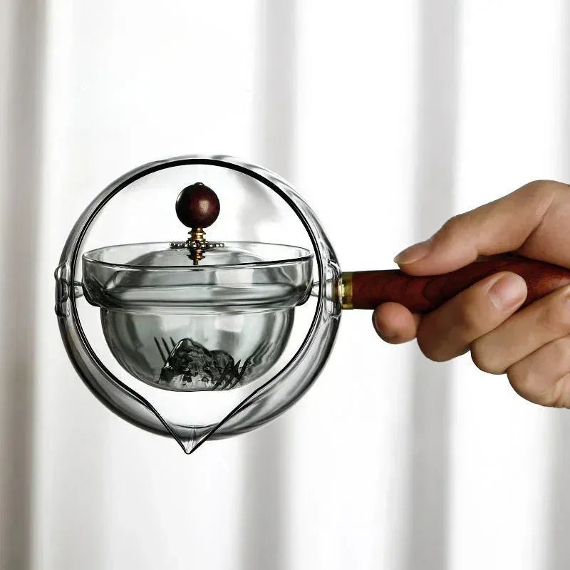Semi-automatic rotary glass teapot with wooden handle and infuser, in grey and transparent colour options.