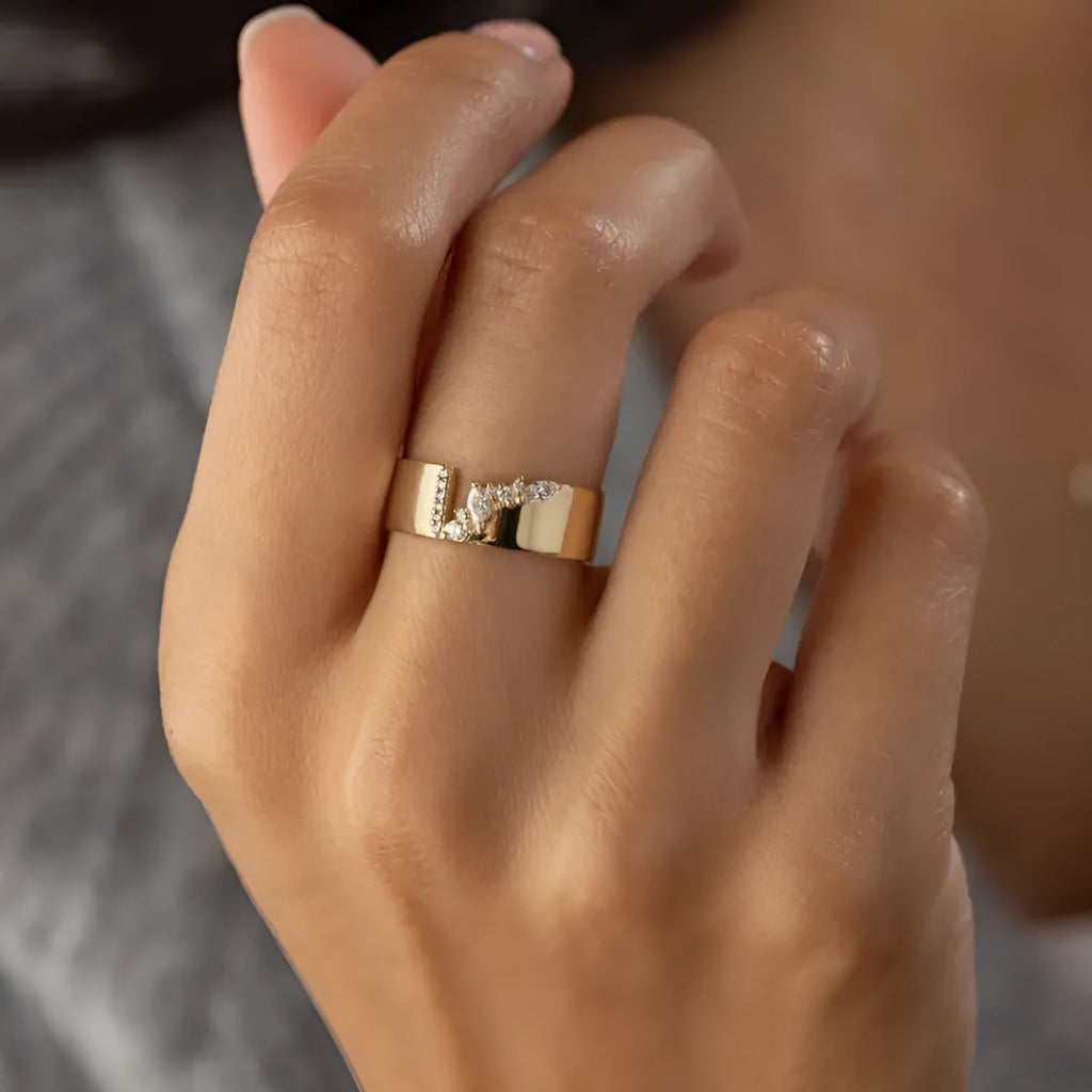 Women's gold electroplated zircon ring on finger showing brilliant stones and metallic finish