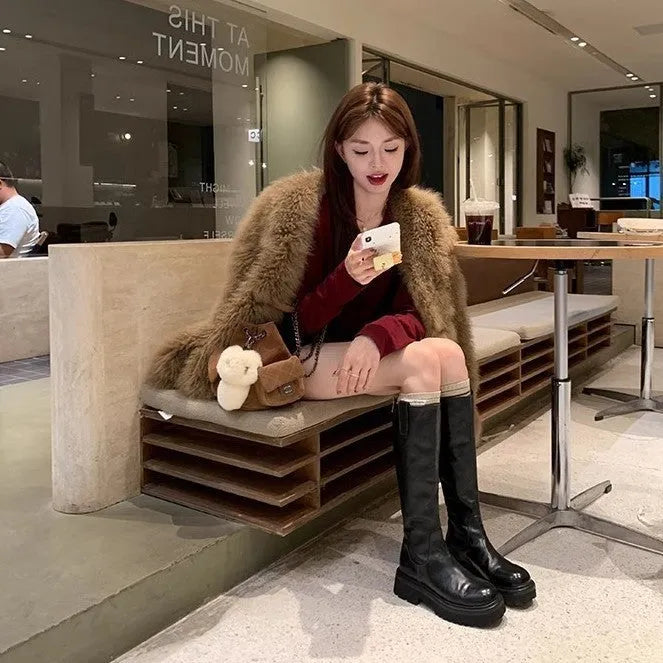 Women's black knee high chunky heel boots with round toe and back zipper.