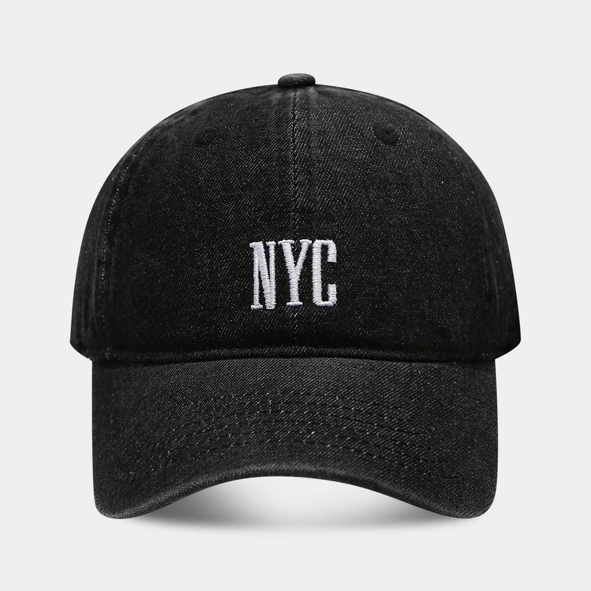 Retro style denim peaked cap with a large alphabet letter on the front, shown in light blue.