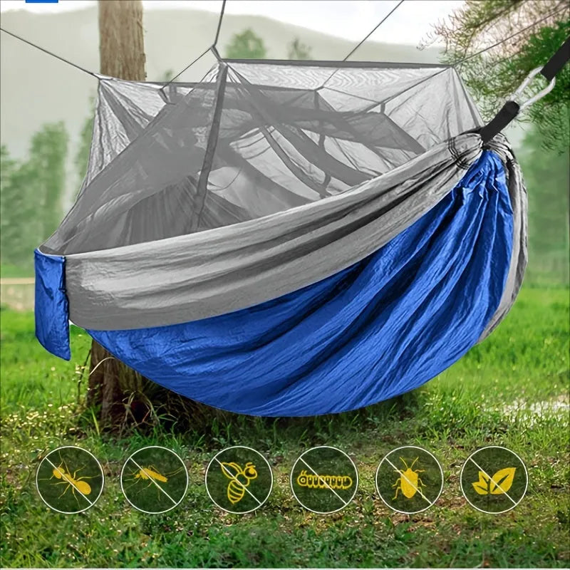 Portable double camping hammock with mosquito net and tree straps in outdoor setting